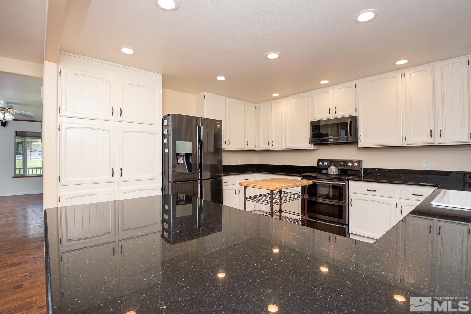 270 Kitts Way Reno, NV 89521 - Photo 4 of 16 a kitchen with stainless steel appliances a refrigerator sink and microwave