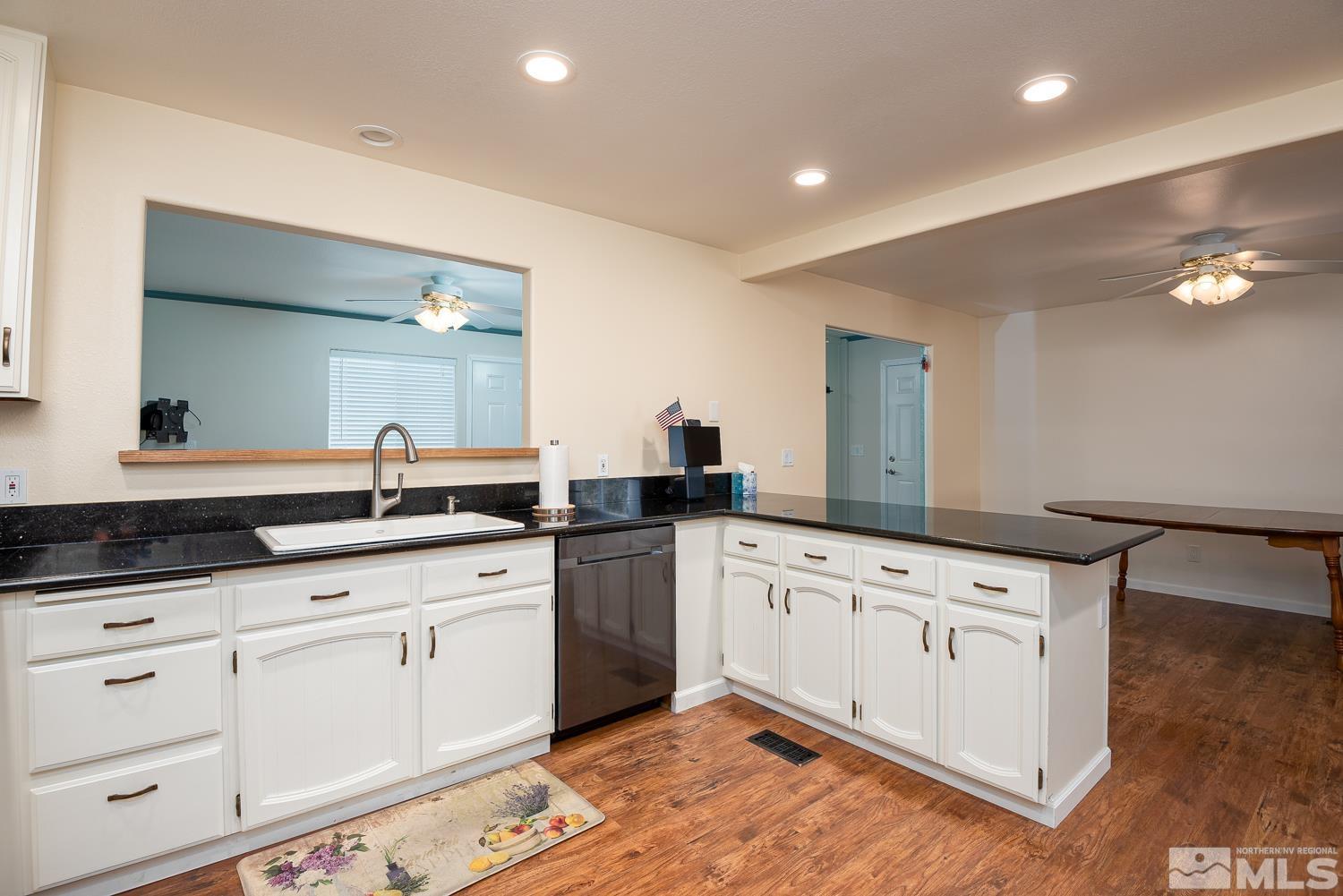 270 Kitts Way Reno, NV 89521 - Photo 5 of 16 a kitchen with granite countertop a sink and cabinets