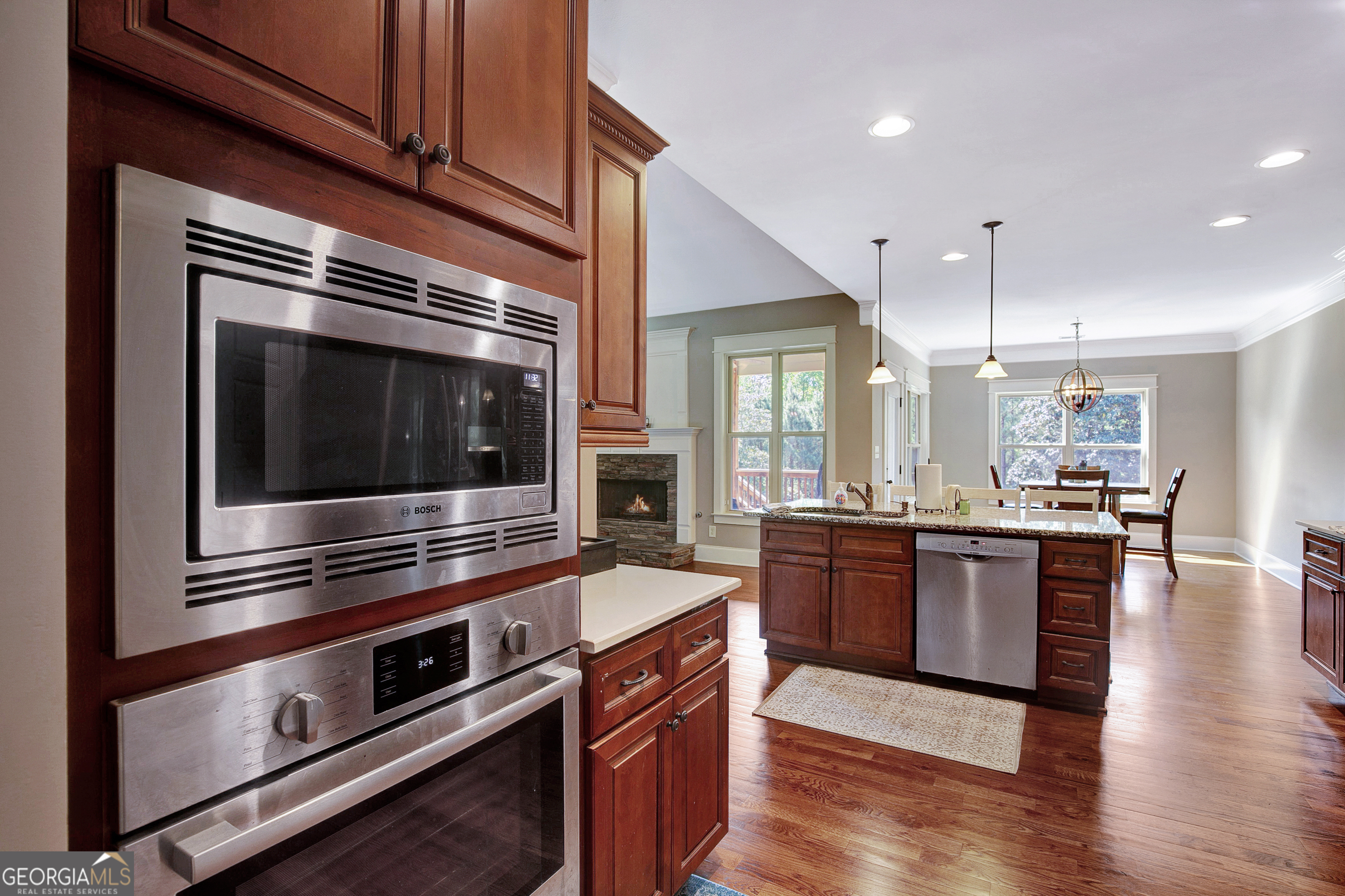 137 Kenmare Row Tyrone, GA 30290 - Photo 70 of 91 a kitchen with stainless steel appliances kitchen island granite countertop a stove a sink and a microwave