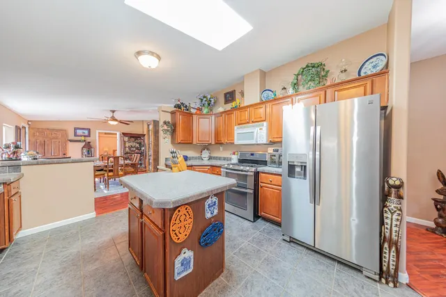 a view of a hallway with wooden floor and a bathroom