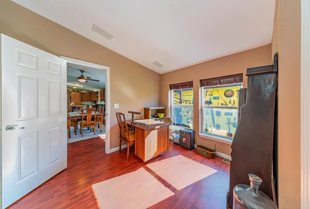 a spacious bathroom with a granite countertop sink and a mirror