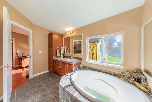 a view of a walk in closet with clothes and shoes