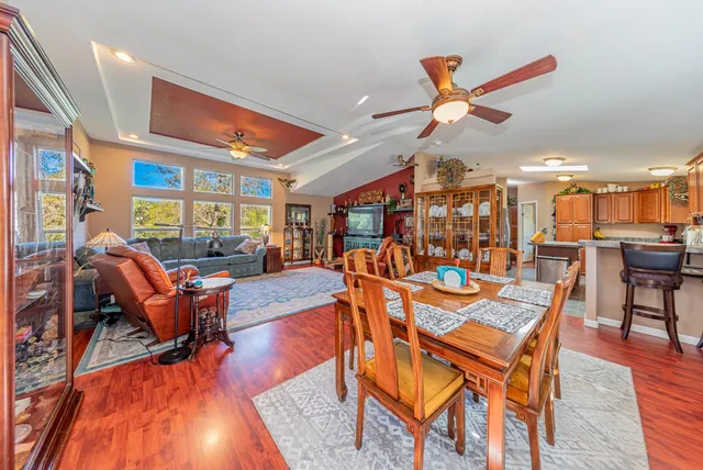 a dining room with furniture and a large window