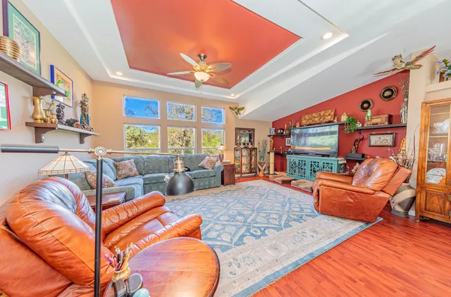 a living room with furniture a rug and a chandelier