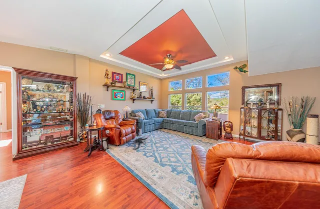 a living room with furniture a rug and a large window