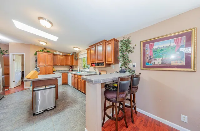 a dining room with furniture and a floor to ceiling window