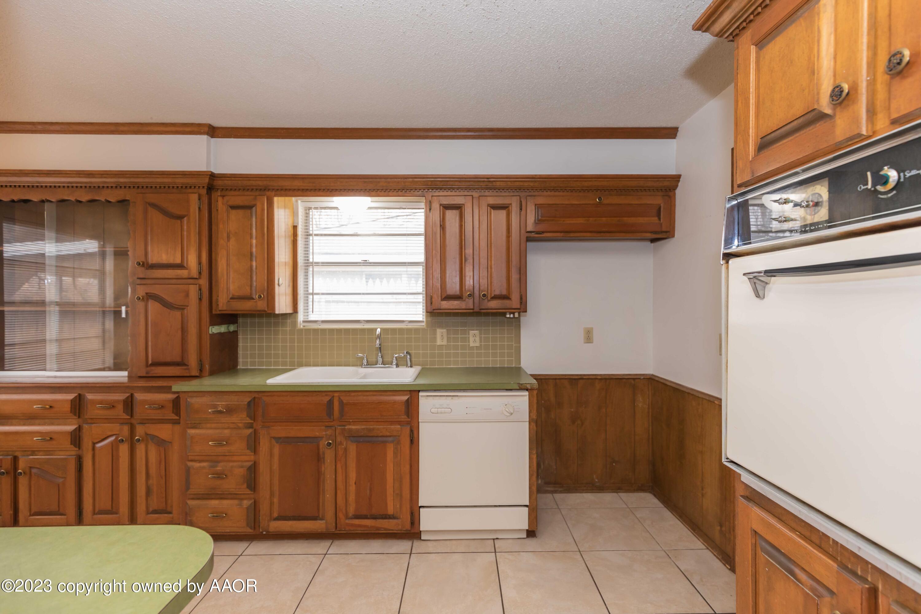 3410 Harmony Street Amarillo, TX 79109 - Photo 11 of 41 a kitchen with a sink and cabinets