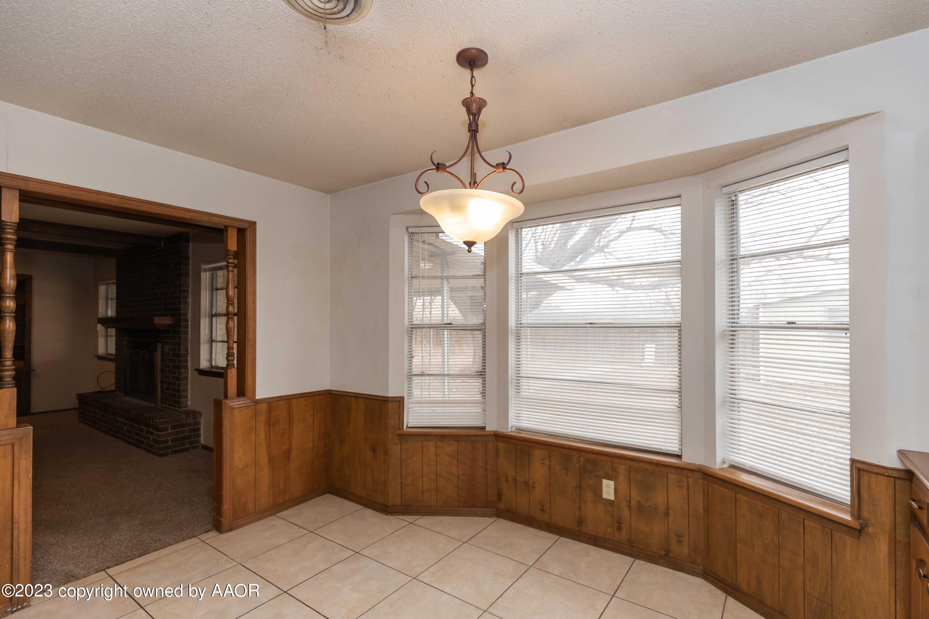 3410 Harmony Street Amarillo, TX 79109 - Photo 14 of 41 a kitchen with a window and a chandelier