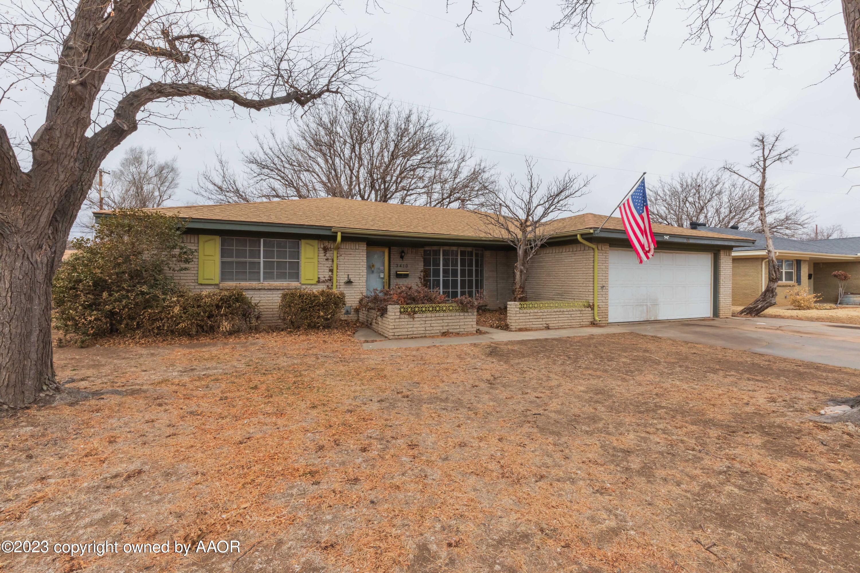 3410 Harmony Street Amarillo, TX 79109 - Photo 2 of 41 a front view of a house with a yard and garage
