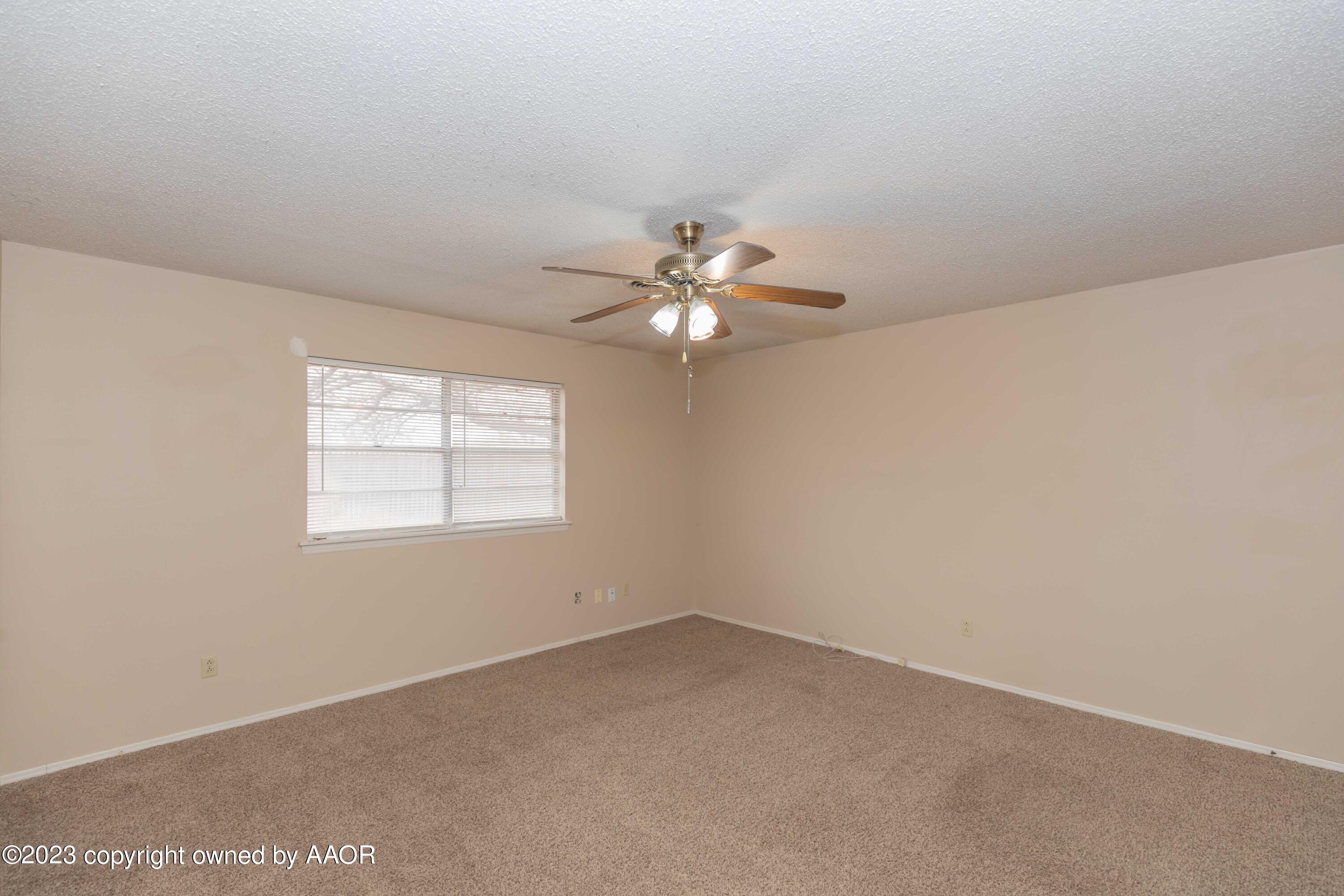 3410 Harmony Street Amarillo, TX 79109 - Photo 22 of 41 an empty room with a window and a fan