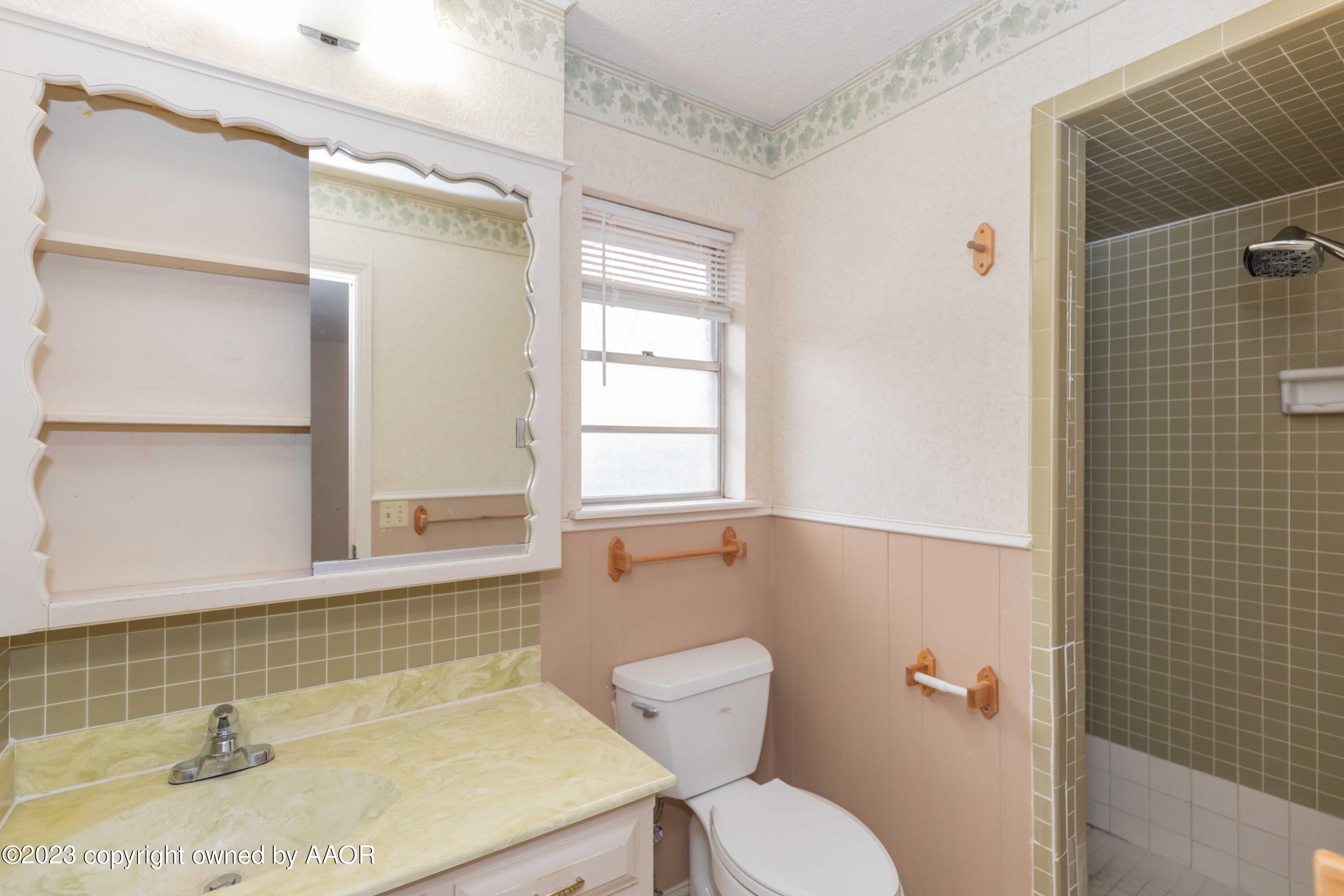 3410 Harmony Street Amarillo, TX 79109 - Photo 24 of 41 a bathroom with a sink a toilet and shower