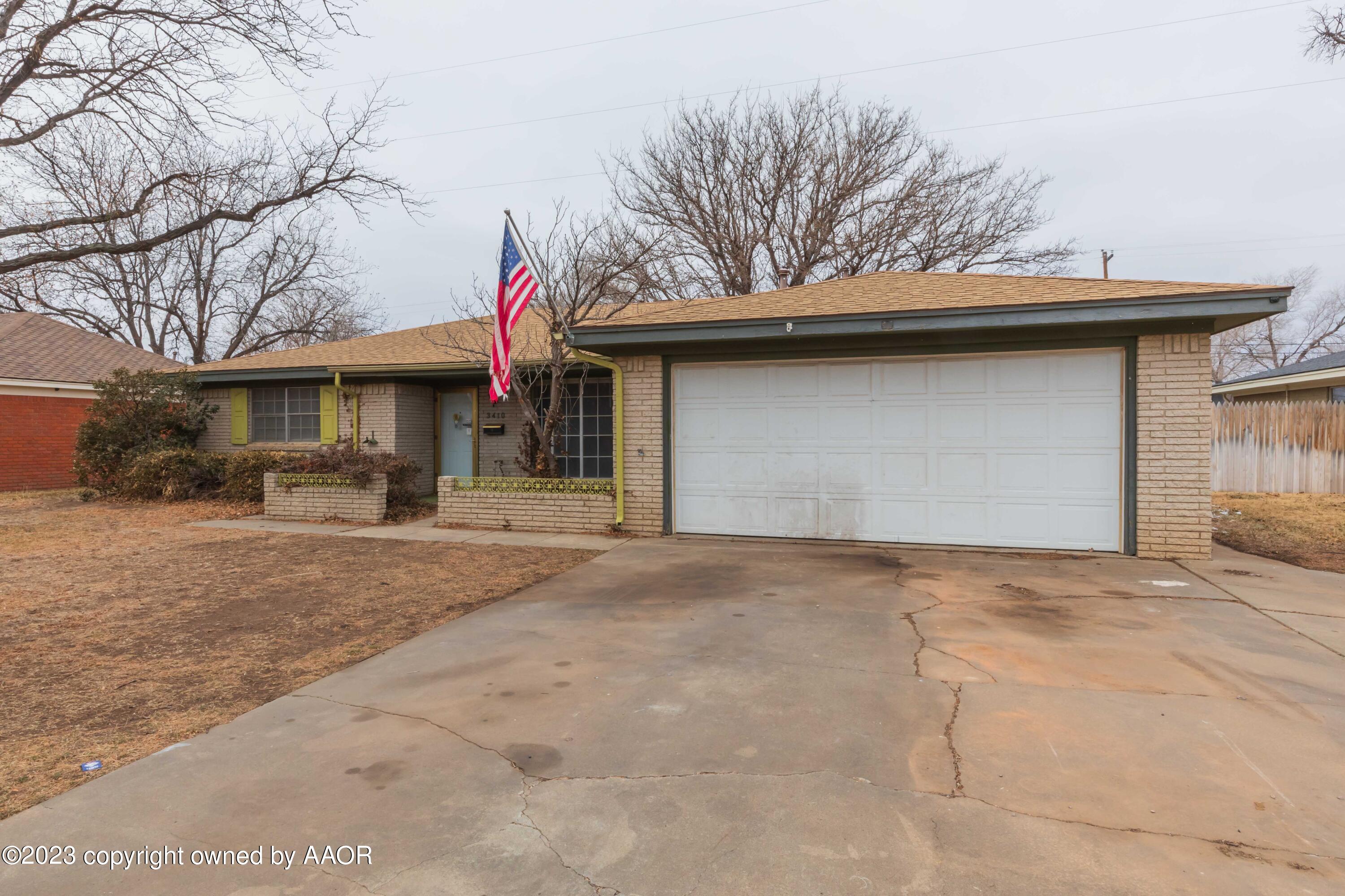 3410 Harmony Street Amarillo, TX 79109 - Photo 3 of 41 a front view of a house with a yard and garage