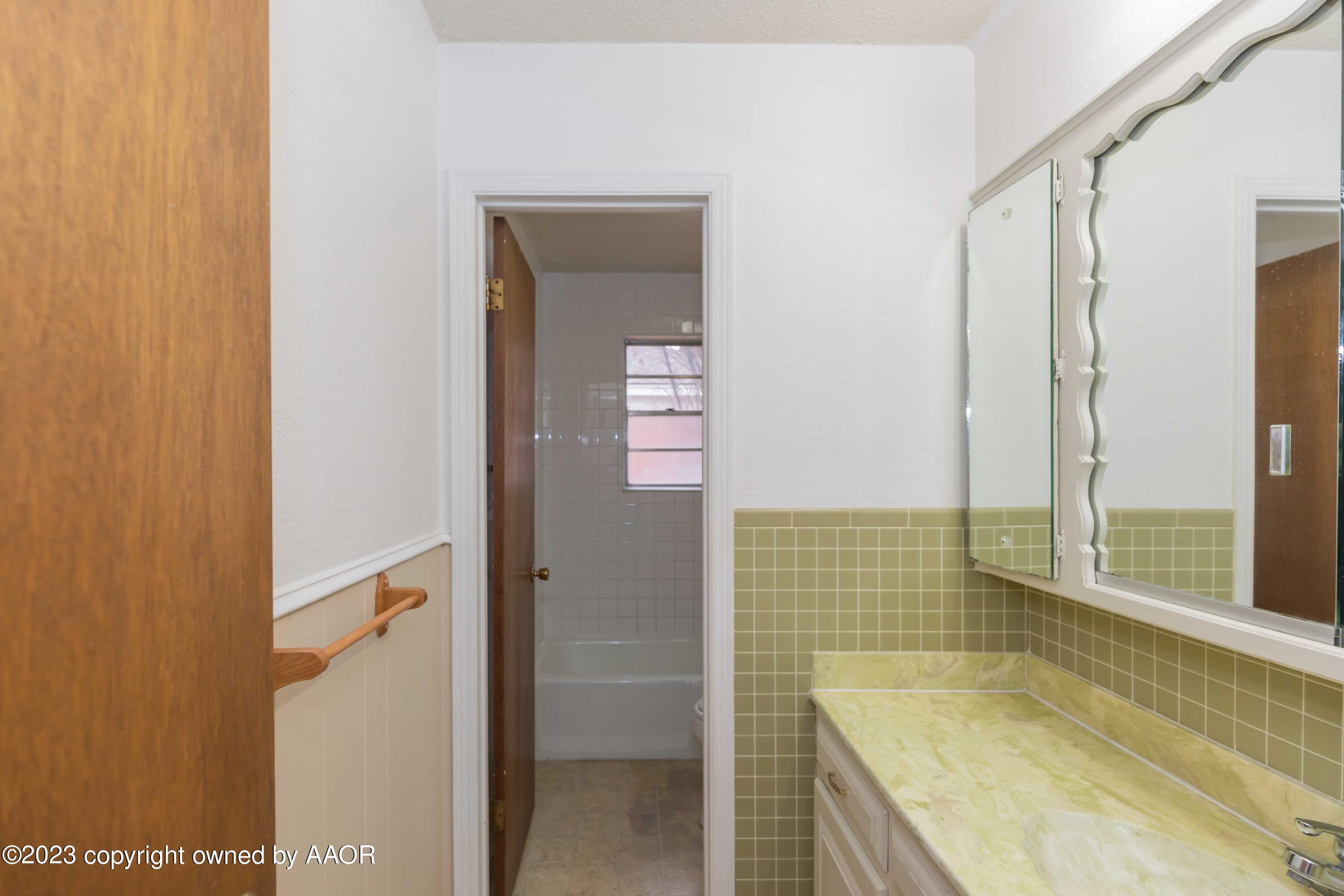 3410 Harmony Street Amarillo, TX 79109 - Photo 31 of 41 a bathroom with a granite countertop sink and shower