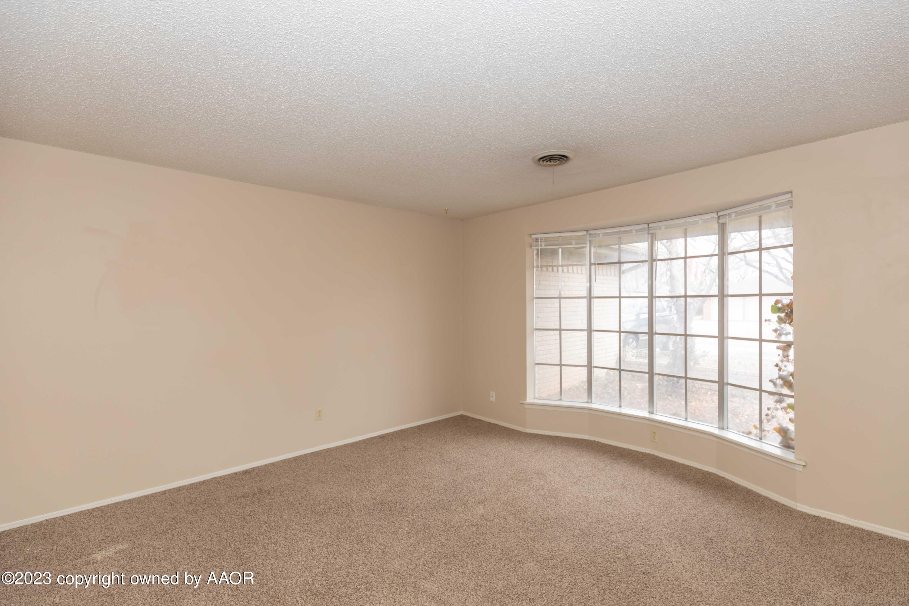 3410 Harmony Street Amarillo, TX 79109 - Photo 4 of 41 wooden floor in an empty room with a window