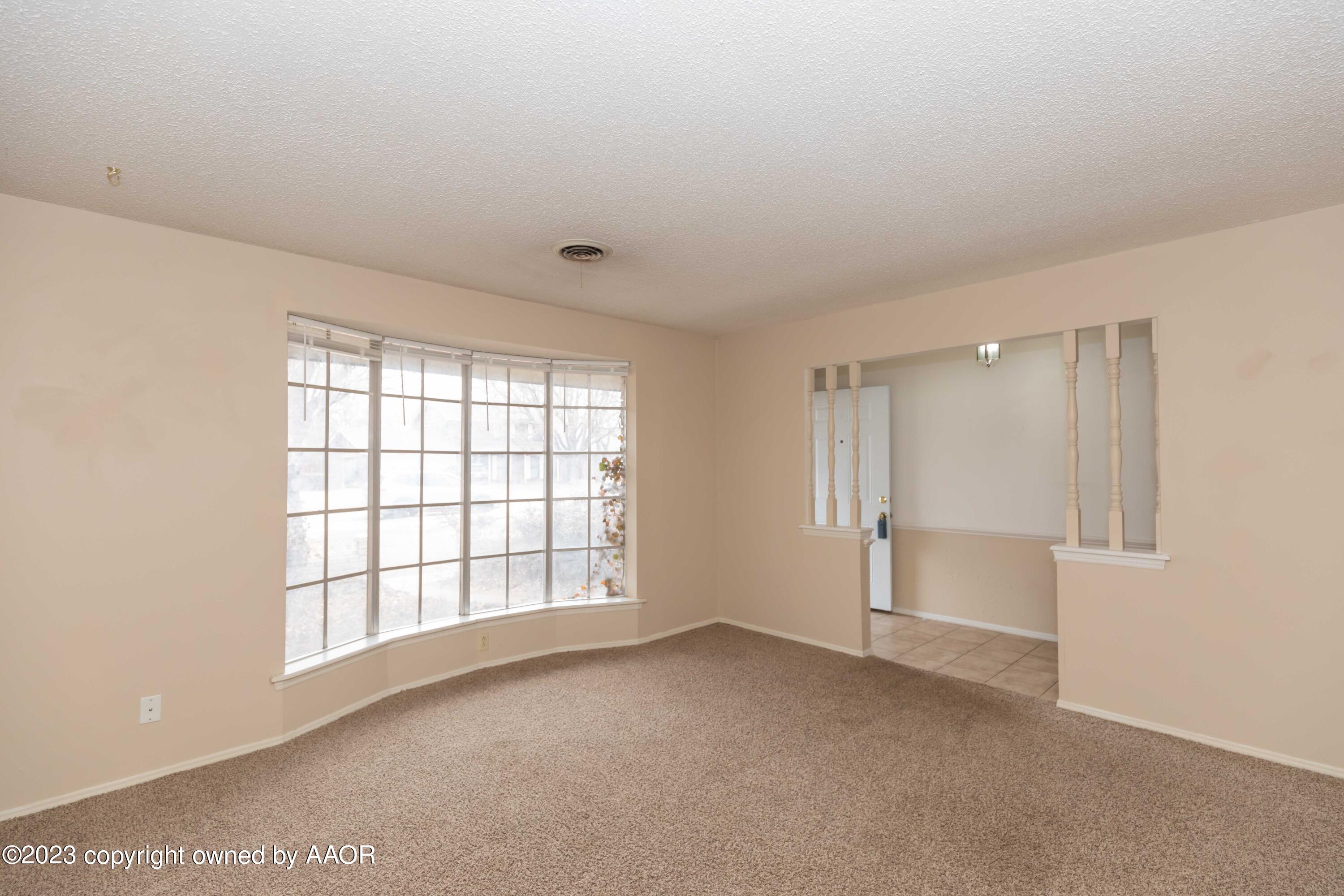 3410 Harmony Street Amarillo, TX 79109 - Photo 5 of 41 a view of an empty room with a window