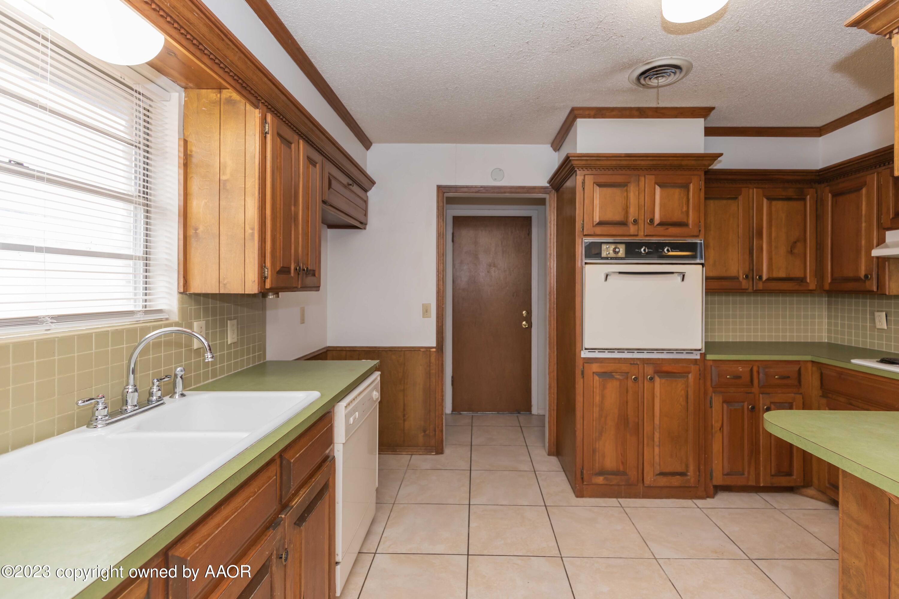 3410 Harmony Street Amarillo, TX 79109 - Photo 8 of 41 a kitchen that has a sink and a stove in it