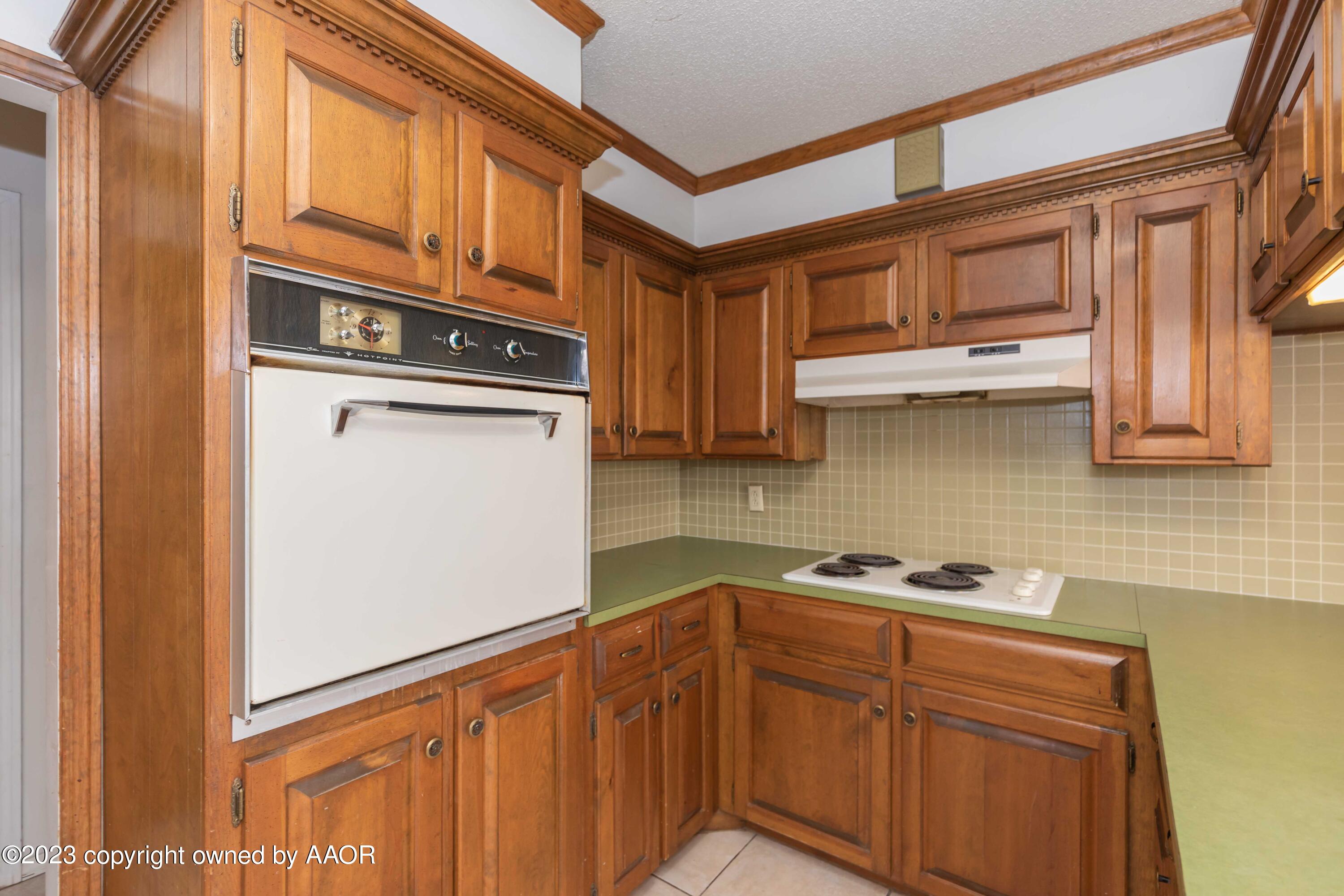 3410 Harmony Street Amarillo, TX 79109 - Photo 10 of 41 a kitchen with stainless steel appliances granite countertop a refrigerator and a stove top oven