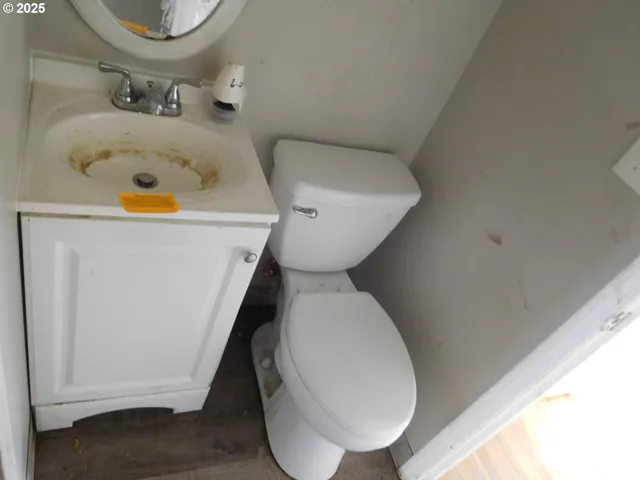 a bathroom with a sink mirror vanity and toilet
