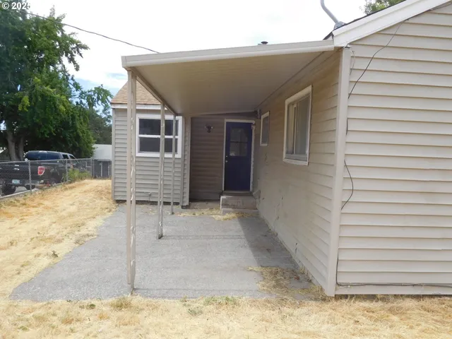 a view of a house with snow on the road
