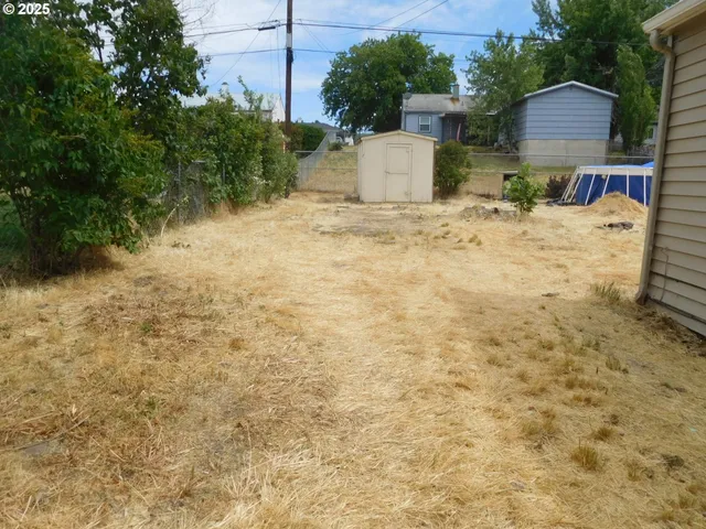 a view of a house with wooden fence
