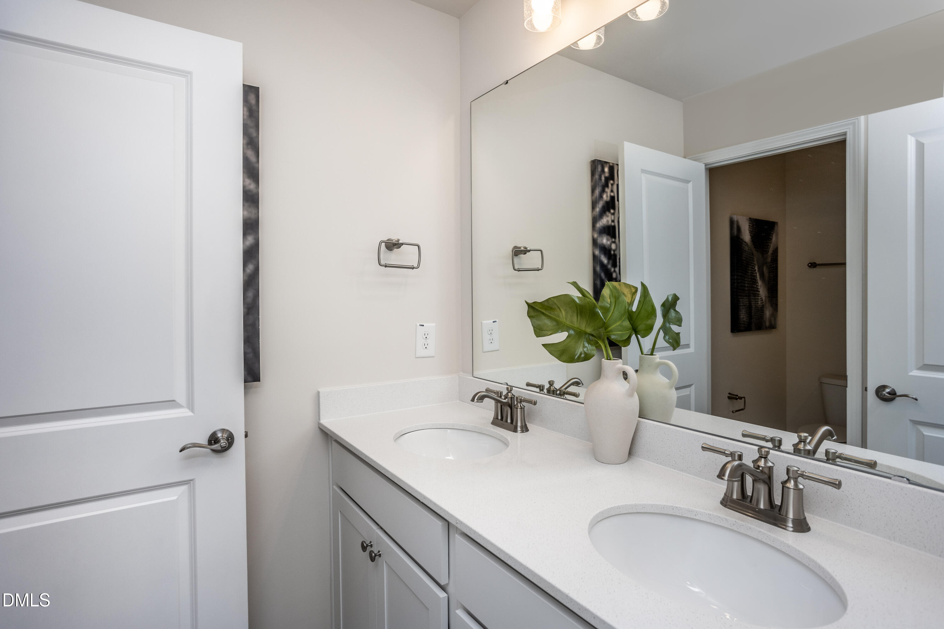 215 Broomside Avenue Raleigh, NC 27603 - Photo 16 of 25 a bathroom with double sink and a mirror