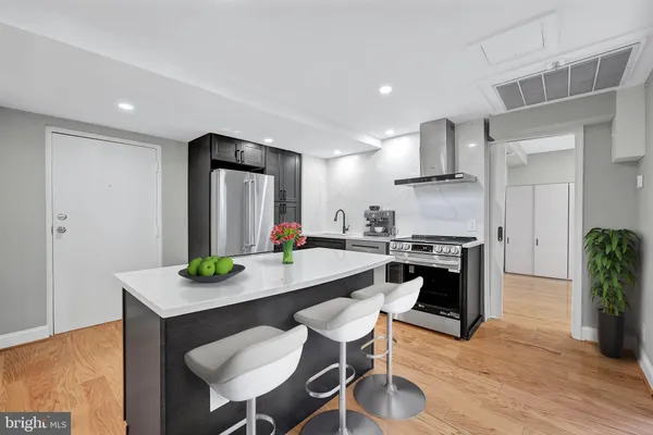 a kitchen with stainless steel appliances granite countertop a stove and a refrigerator