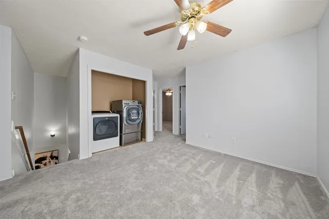 a view of a livingroom with a chandelier fan