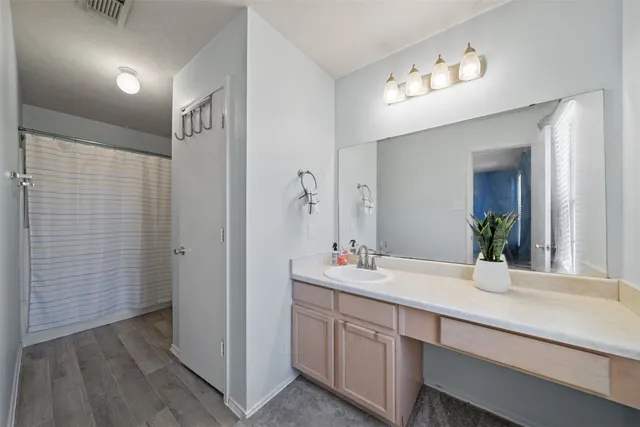 a bathroom with a double vanity sink and a mirror