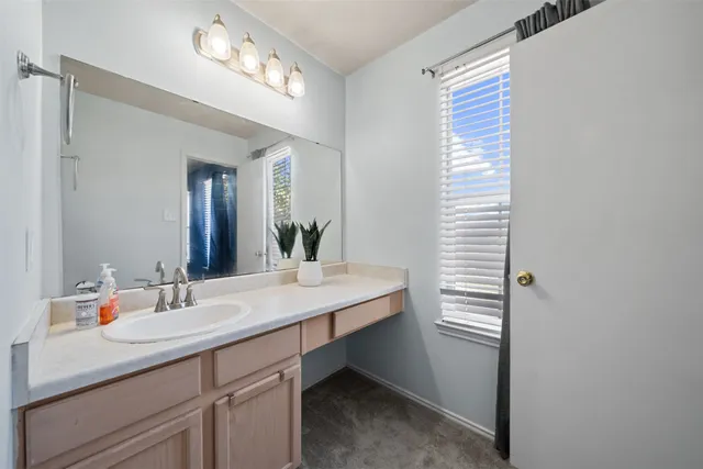 a bathroom with a sink vanity and a mirror