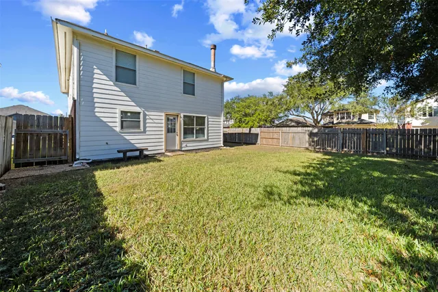 a house view with swimming pool in front of it