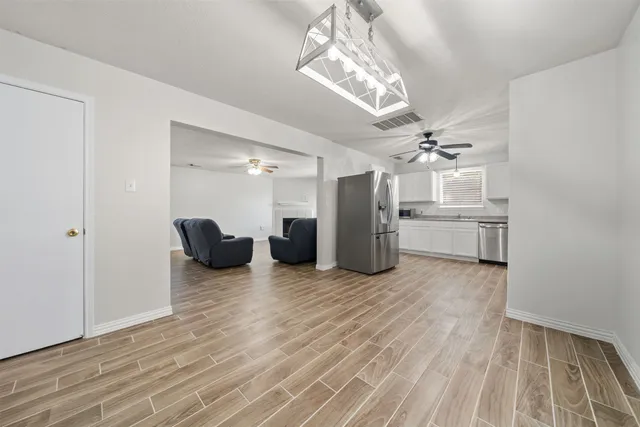 a view of a livingroom with a furniture wooden floor and a chandelier