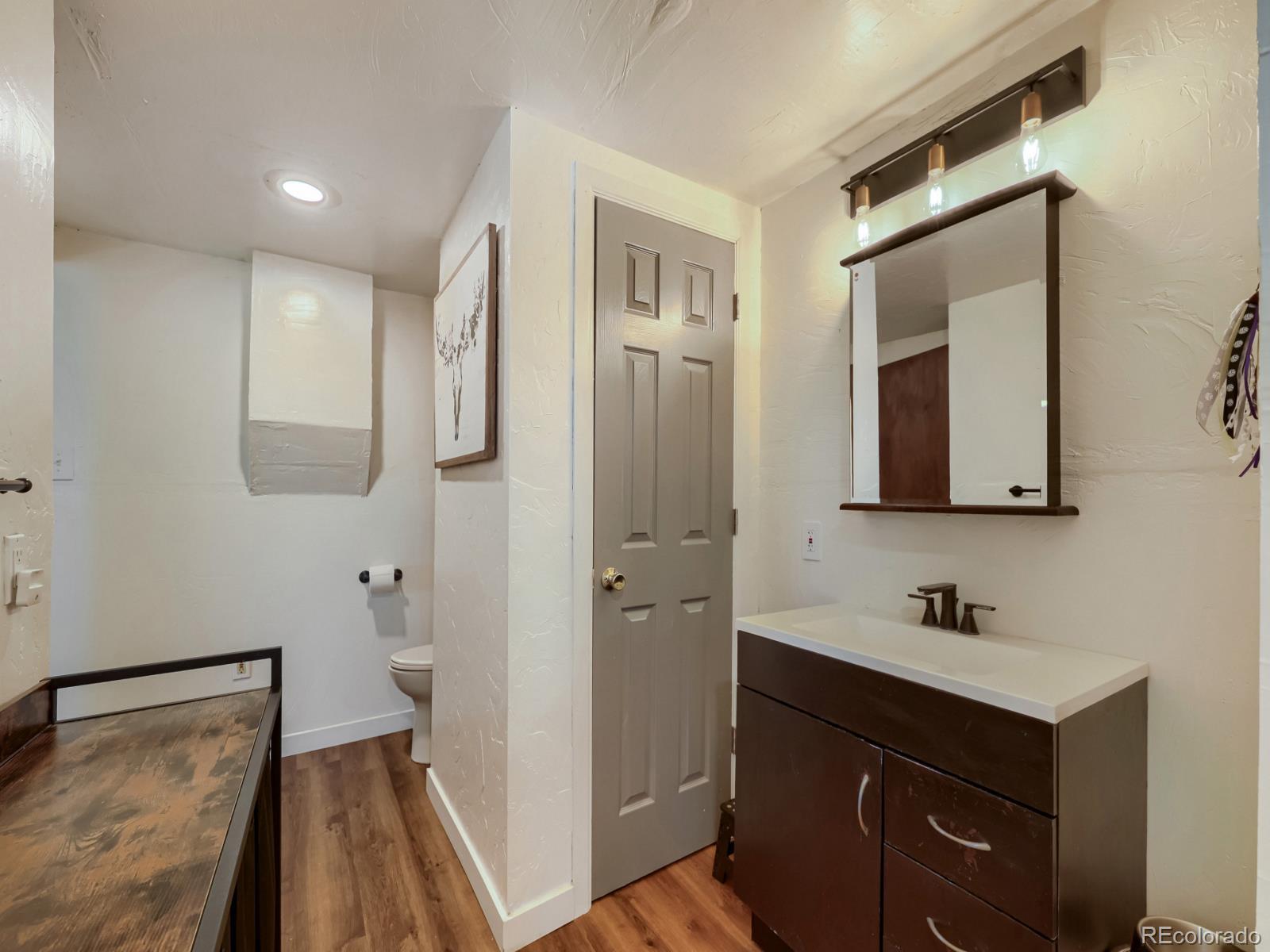 24379 Main Street Elbert, CO 80106 - Photo 14 of 29 a bathroom with a sink and a mirror