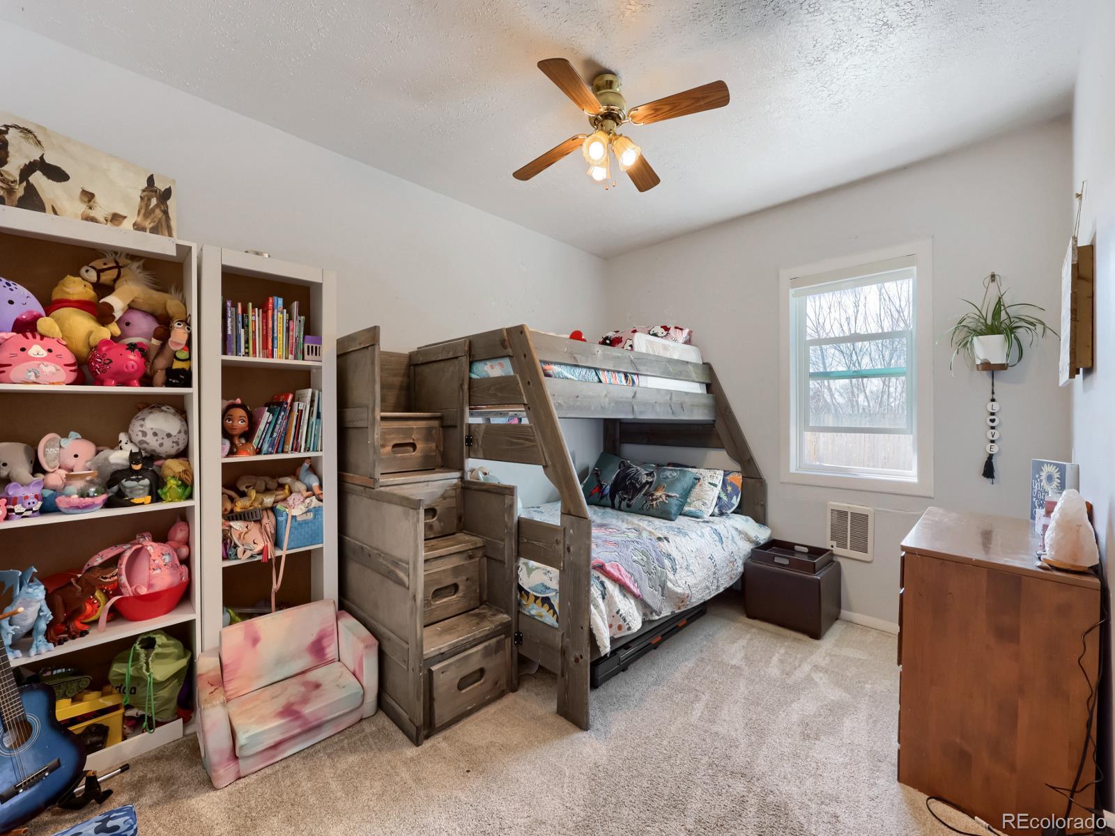 24379 Main Street Elbert, CO 80106 - Photo 15 of 29 a bedroom with furniture and a book shelf