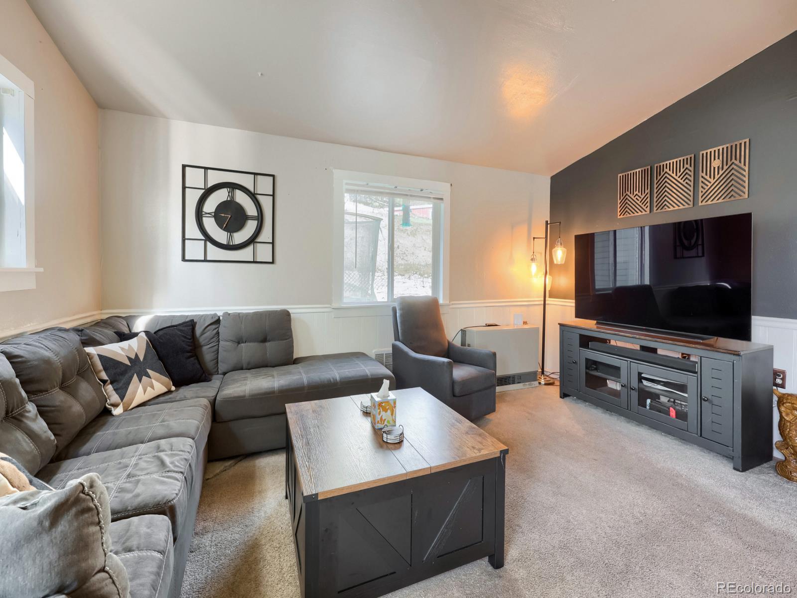 24379 Main Street Elbert, CO 80106 - Photo 2 of 29 a living room with furniture and a flat screen tv