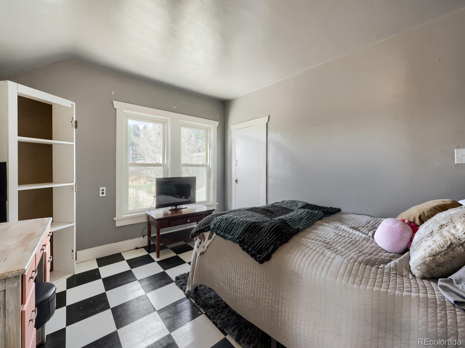 24379 Main Street Elbert, CO 80106 - Photo 23 of 29 a bedroom with a bed and a window