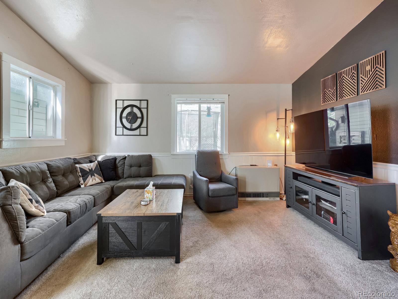 24379 Main Street Elbert, CO 80106 - Photo 7 of 29 a living room with furniture and a flat screen tv