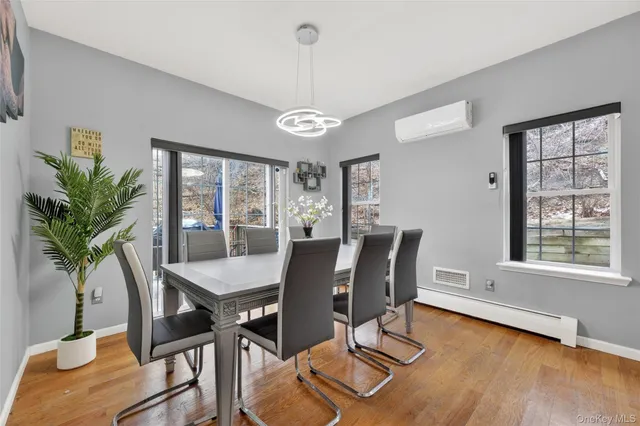 a view of a dining room with furniture window and wooden floor