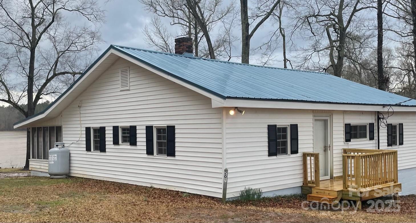 207 Rion Circle Winnsboro, SC 29180 - Photo 3 of 17 a view of a white house with large windows