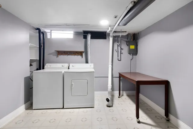 a utility room with cabinets and washer dryer