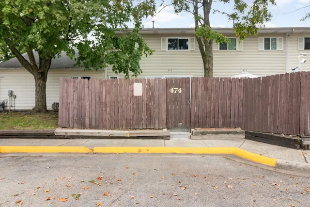 a view of swimming pool with a small yard and wooden fence