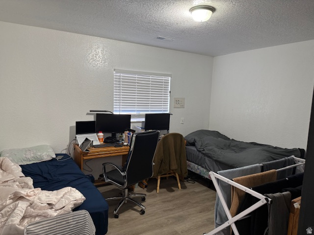 72 880 North, Unit 2 Provo, UT 84604 - Photo 6 of 9 Room featuring wood-finish flooring, a window with horizontal blinds, and a flush-mount ceiling light fixture