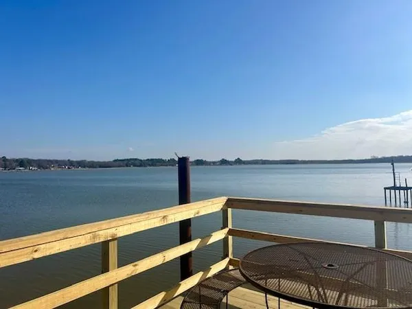 a wooden bench sitting next to a lake