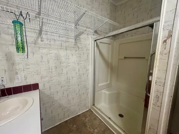 a bathroom with a shower and a sink