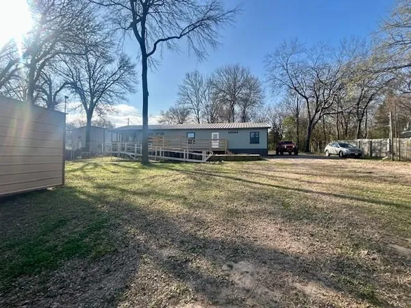 a view of swimming pool with outdoor seating and yard in the back