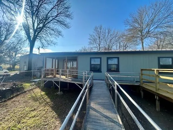 a view of house with swimming pool outdoor seating