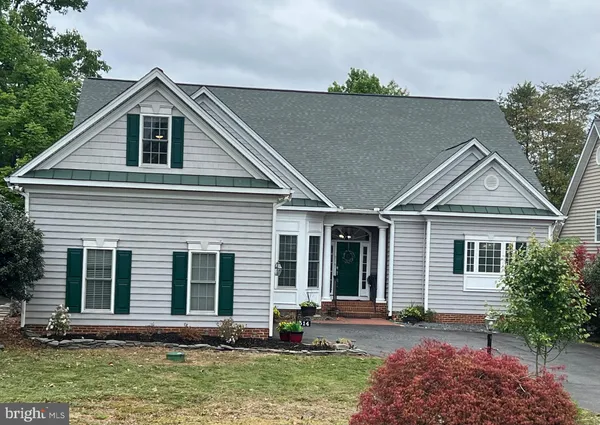 a front view of a house with yard