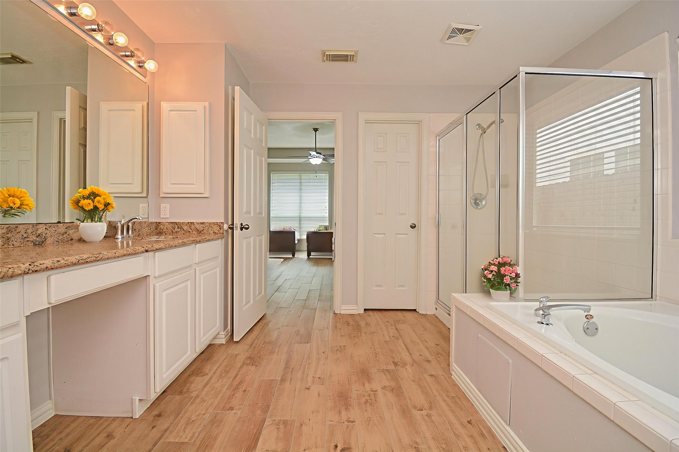 4007 Gazebo Lane Missouri City, TX 77459 - Photo 12 of 21 a spacious bathroom with a granite countertop tub sink a mirror a vanity and shower