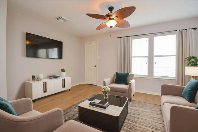 a view of a house with a yard and sitting area