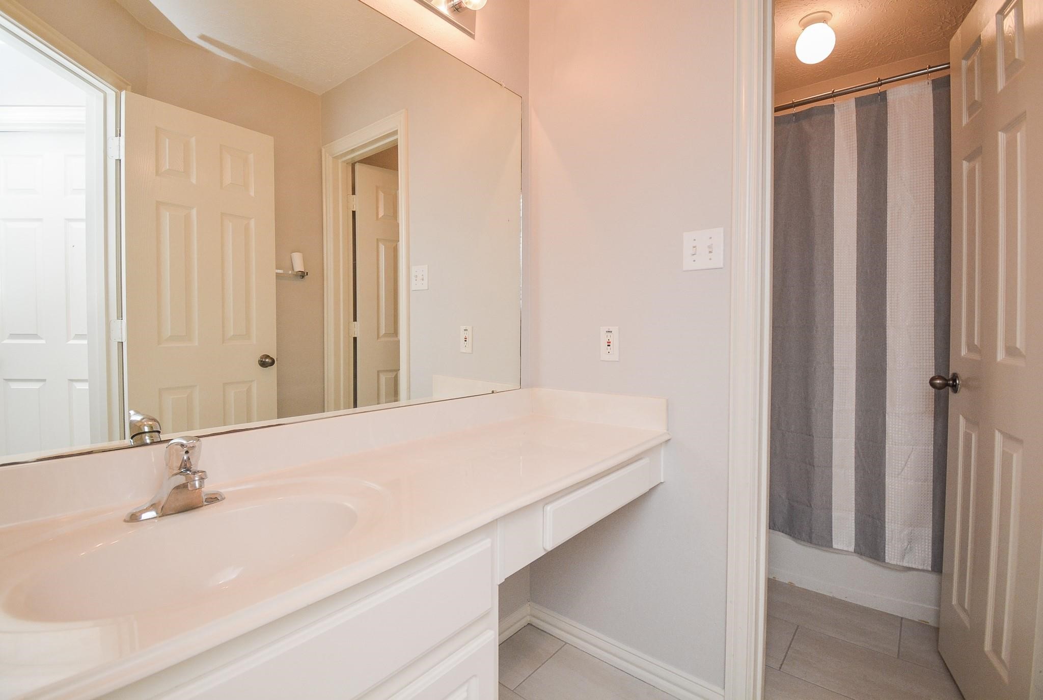 4007 Gazebo Lane Missouri City, TX 77459 - Photo 17 of 21 a bathroom with a sink and a mirror