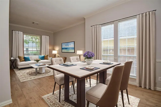 a living room with furniture a large window and a flat screen tv